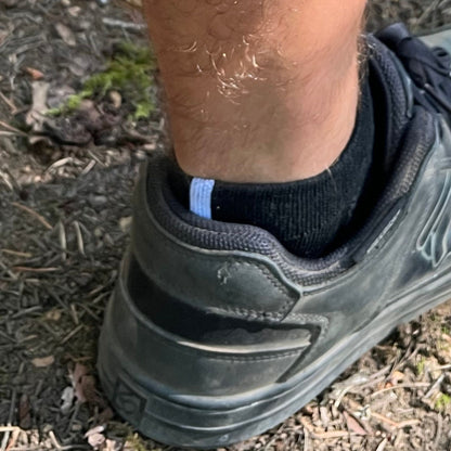 black ankle sock goes above heal on mountain biking shoe