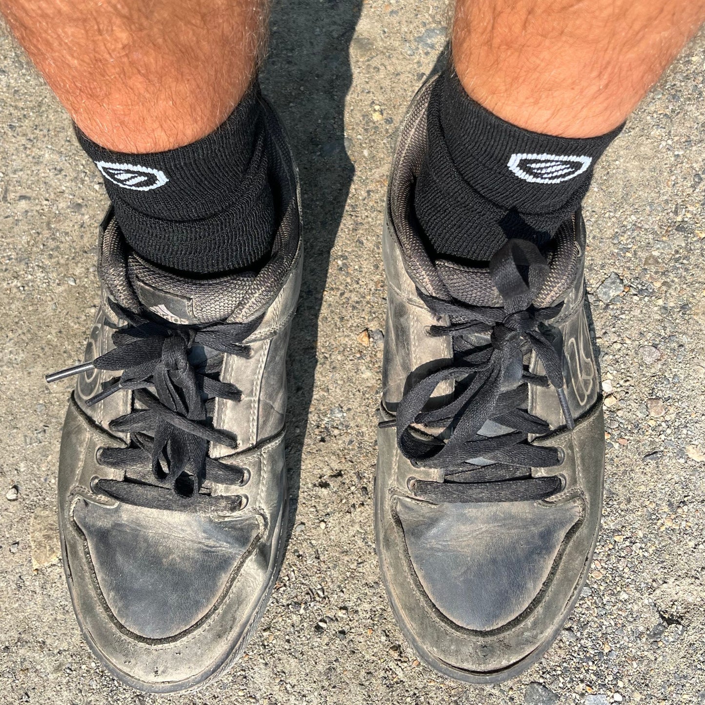 mid length black socks in dusty shoes at the bike park